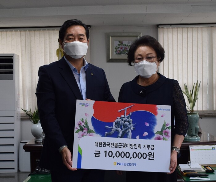 NH농협은행 함용문 부행장(왼쪽)이 강길자 대한민국전몰군경미망인회장(오른쪽)에게 기부금을 전달하고 있다.(사진=NH농협은행)