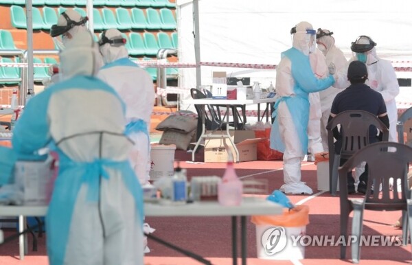 17일 오전 제주시 한림읍 체육관 운동장에 마련된 임시 진료소에서 보건당국 관계자들이 주민들을 대상으로 코로나19 검사를 하고 있다.[사진= 연합뉴스]